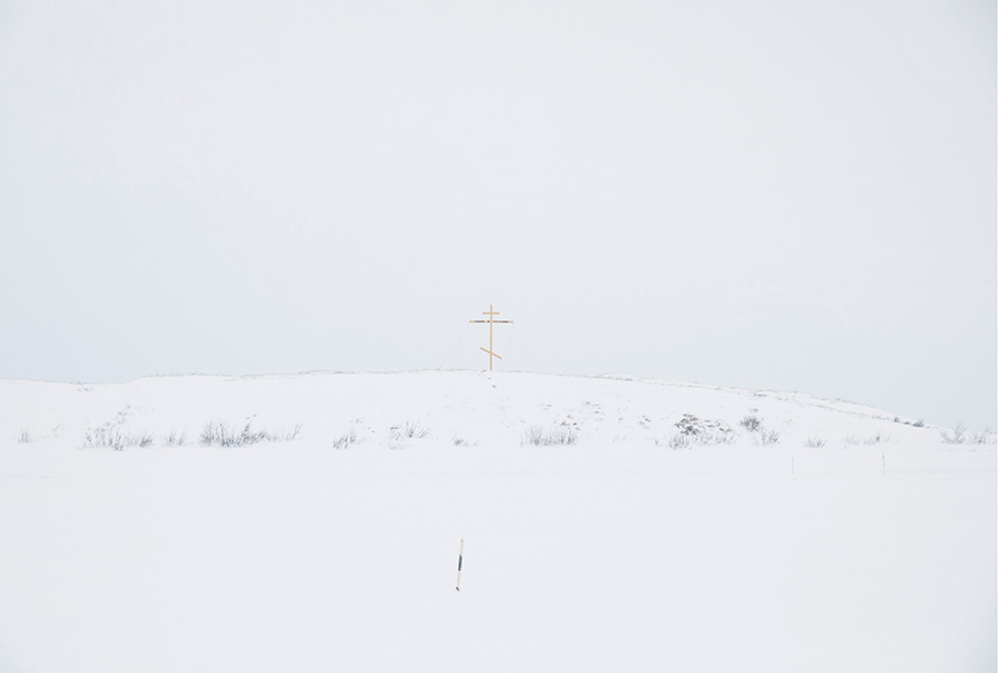 An improvised cross, which marks the border between the village and the tundra. For tundra people, this cross marks the border between their world and the world of the "others" (non-tundra people) as they refer to them. Crossing this border is accompanied by many fears and superstitions, both by tundra people and the "others." 