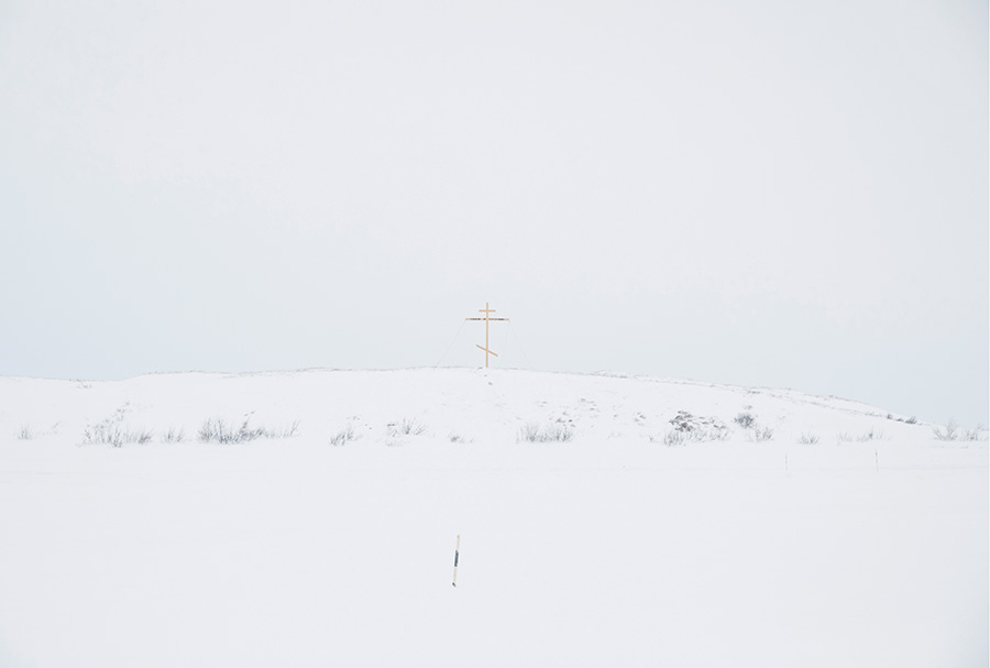 An improvised cross, which marks the border between the village and the tundra. For tundra people, this cross marks the border between their world and the world of the "others" (non-tundra people) as they refer to them. Crossing this border is accompanied by many fears and superstitions, both by tundra people and the "others." 